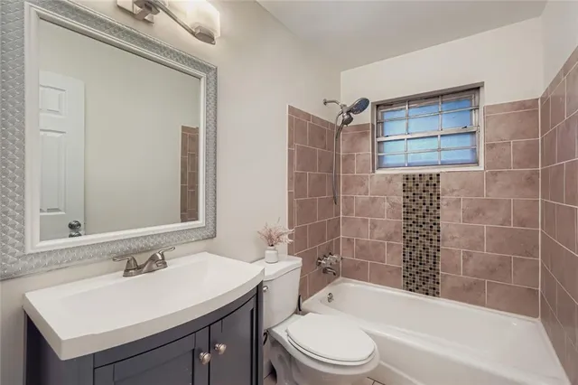 a bathroom with a sink mirror toilet and bathtub