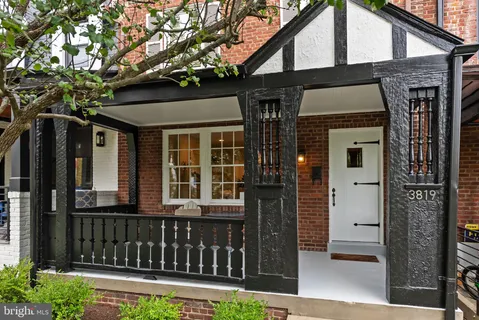 a view of a house with a small yard and wooden floor and fence