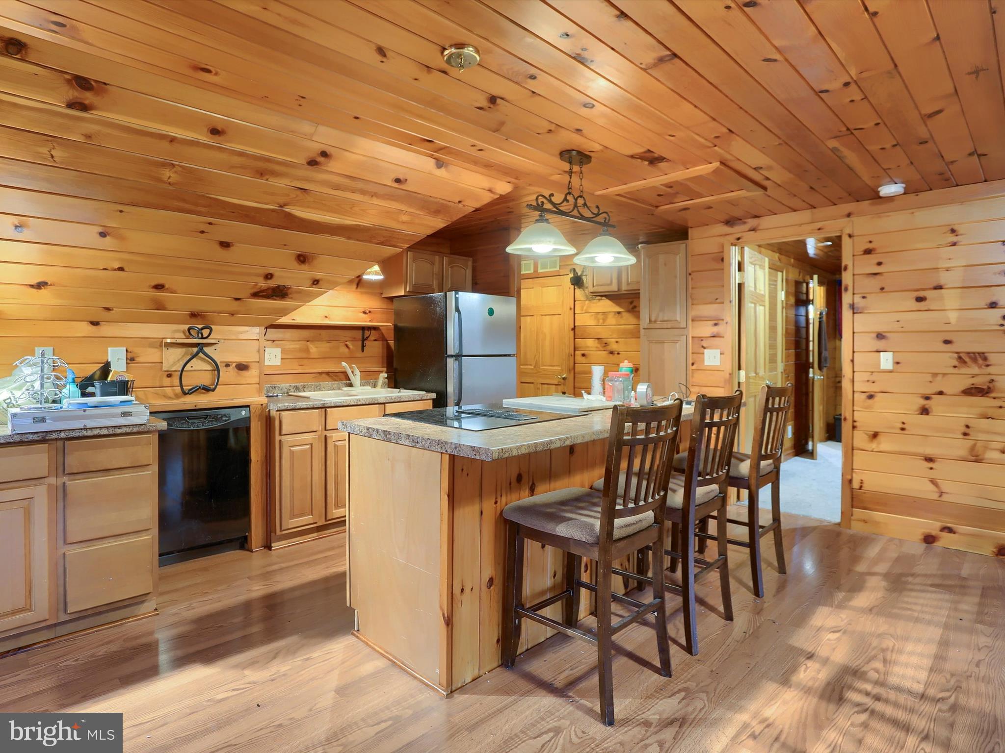 389 Church Road Shermans Dale, PA 17090 - Photo 49 of 88 a kitchen with stainless steel appliances kitchen island granite countertop a table chairs and a sink