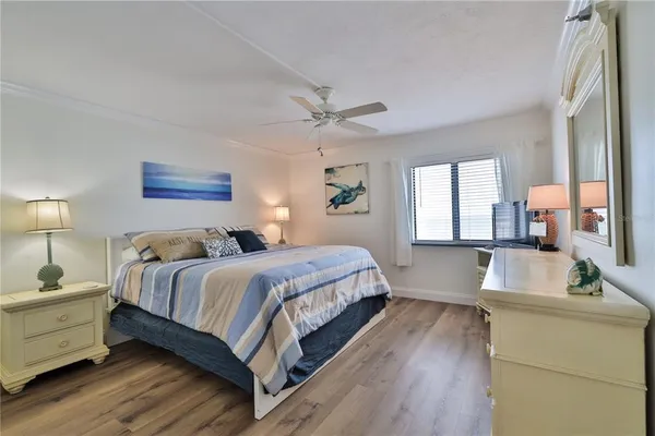 a spacious bedroom with a large bed and a chandelier