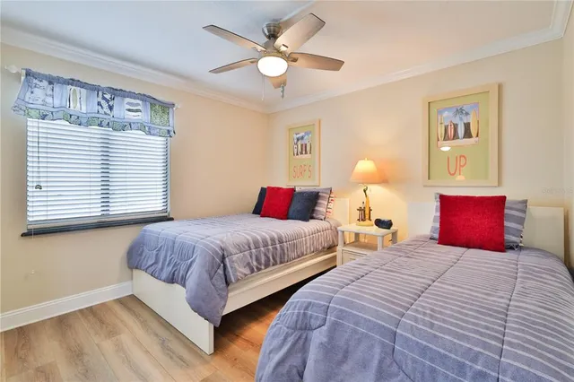 a bedroom with two beds and a chandelier