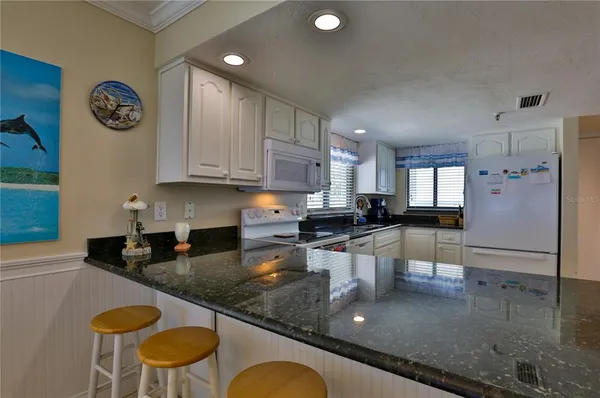 a kitchen with a table chairs and a refrigerator