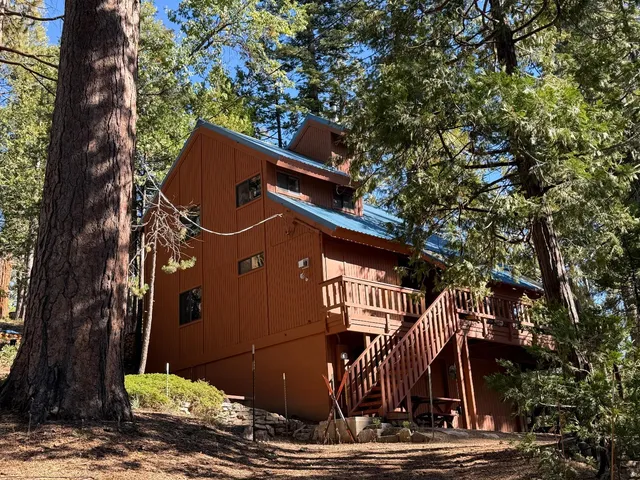 a front view of a house with trees