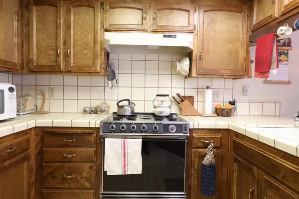 a kitchen with stainless steel appliances granite countertop a stove and a sink