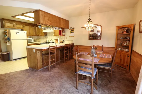 a dining room with a wooden table and chairs