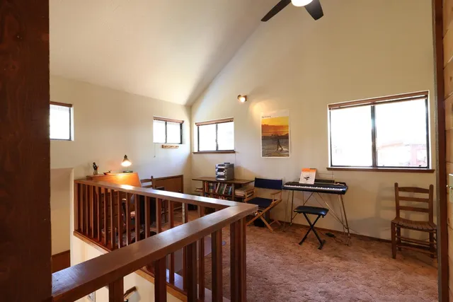 a view of a workspace with furniture and windows