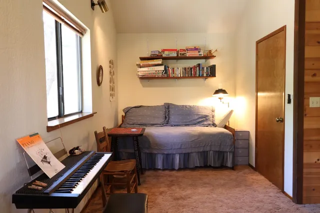 a bedroom with furniture and a window