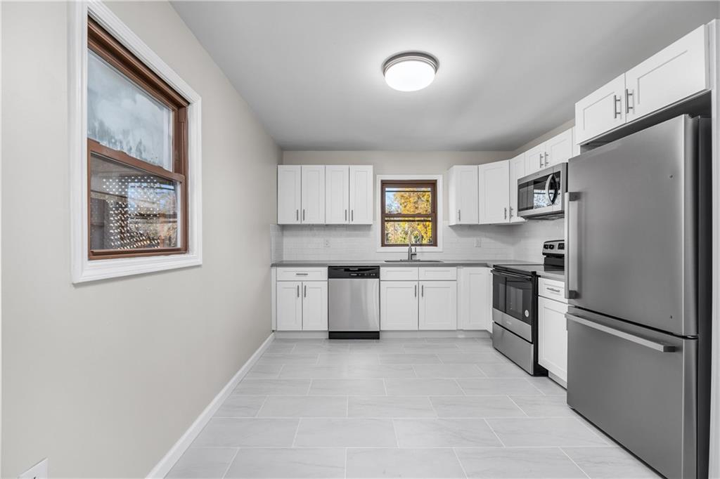 2706 Front Street Monaca, PA 15061 - Photo 7 of 31 a kitchen with white cabinets and stainless steel appliances