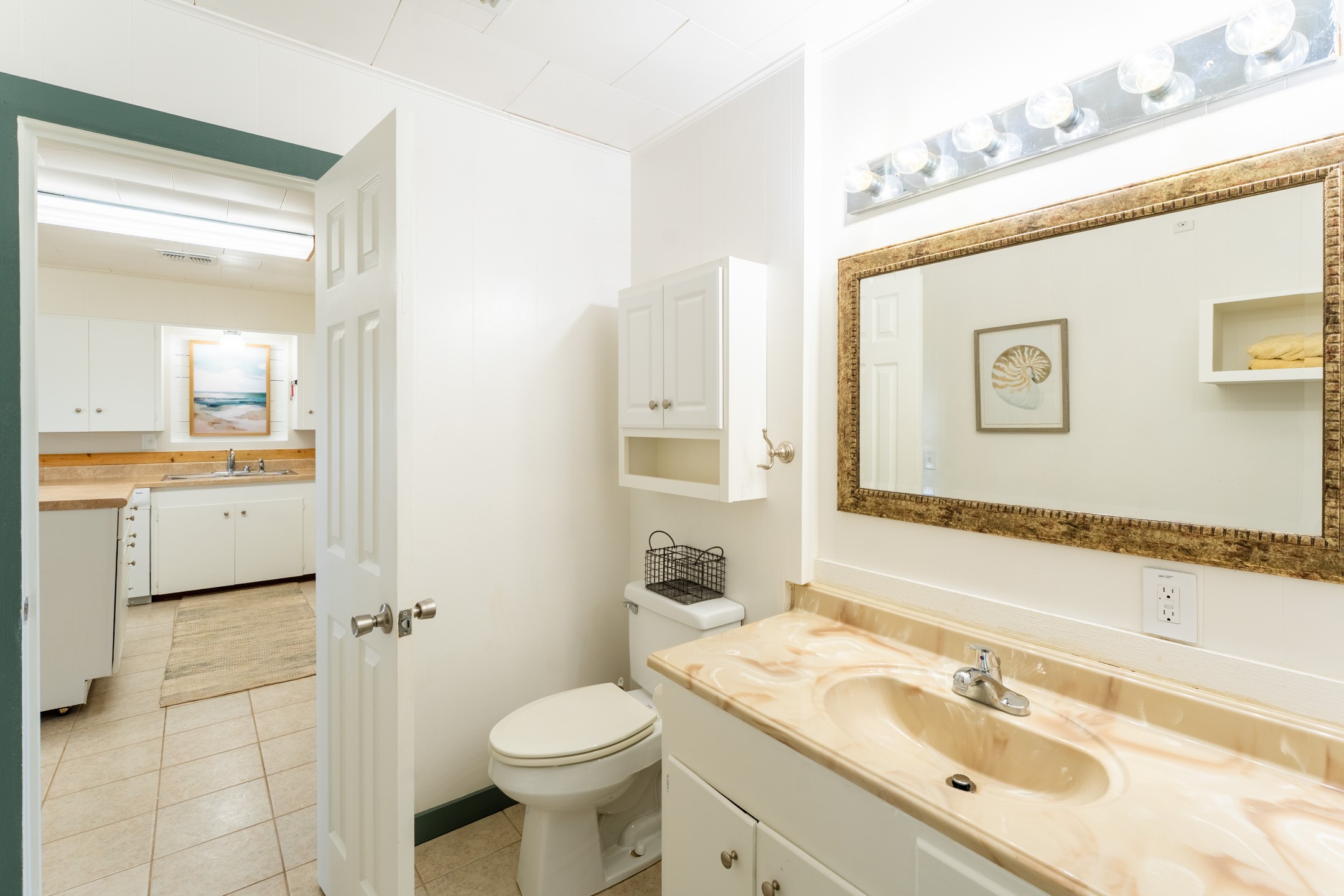 234 El Campo Beach Road Palacios, TX 77465 - Photo 14 of 25 a bathroom with a granite countertop sink mirror vanity and toilet