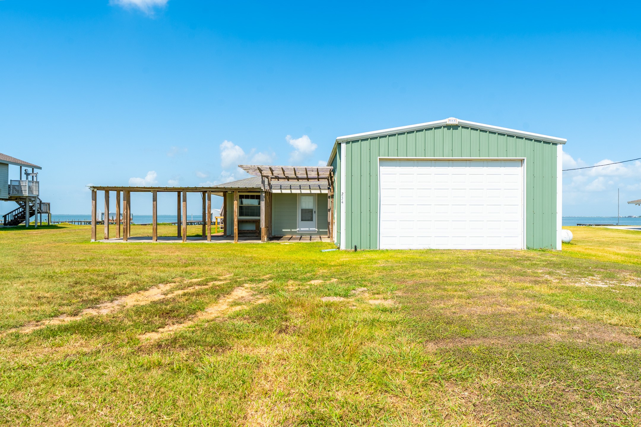 234 El Campo Beach Road Palacios, TX 77465 - Photo 16 of 25 a view of a swimming pool with an outdoor space and seating area