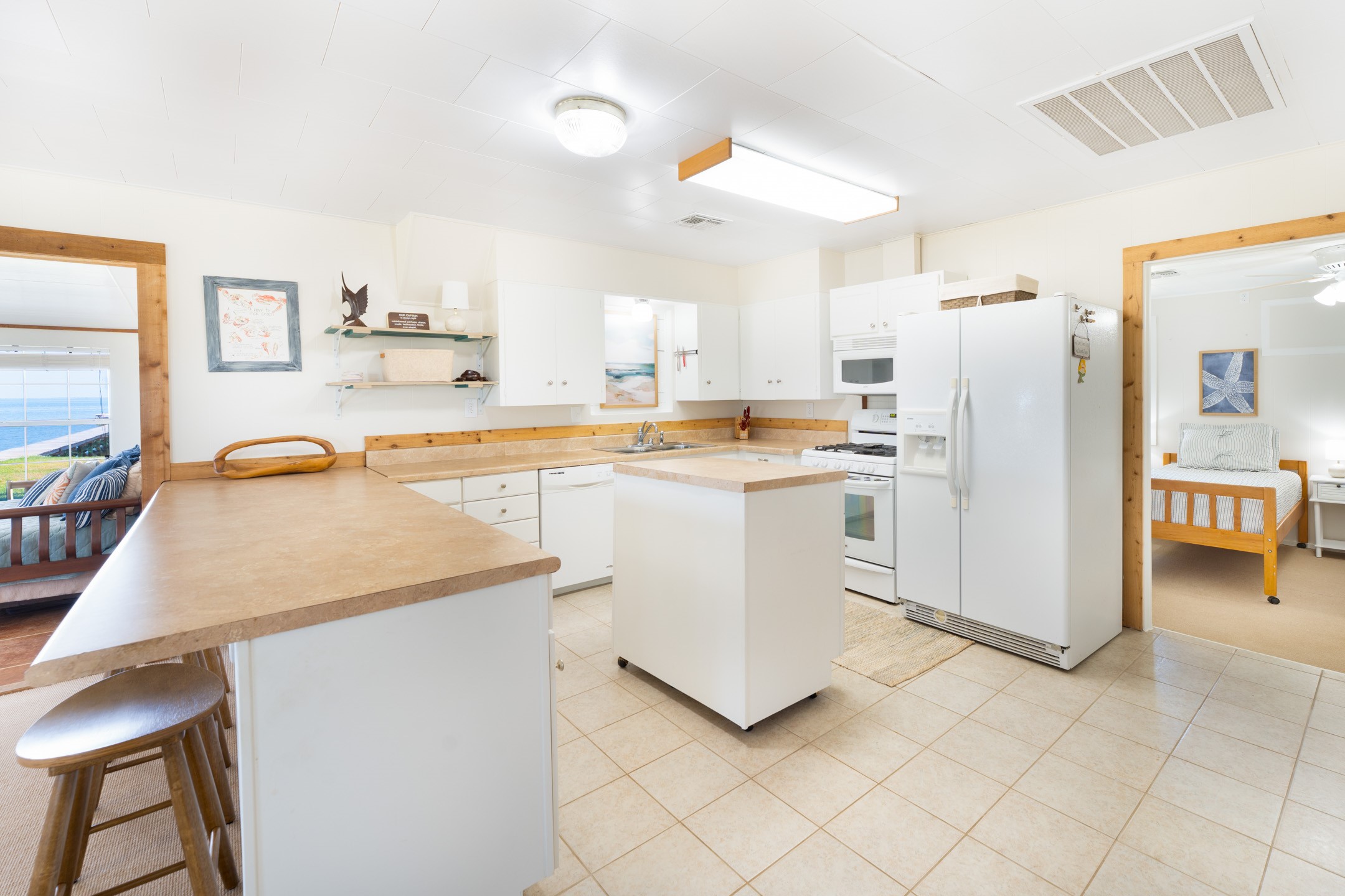 234 El Campo Beach Road Palacios, TX 77465 - Photo 7 of 25 a kitchen with white cabinets and white appliances