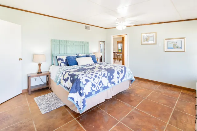 a spacious bedroom with a large bed and a large window