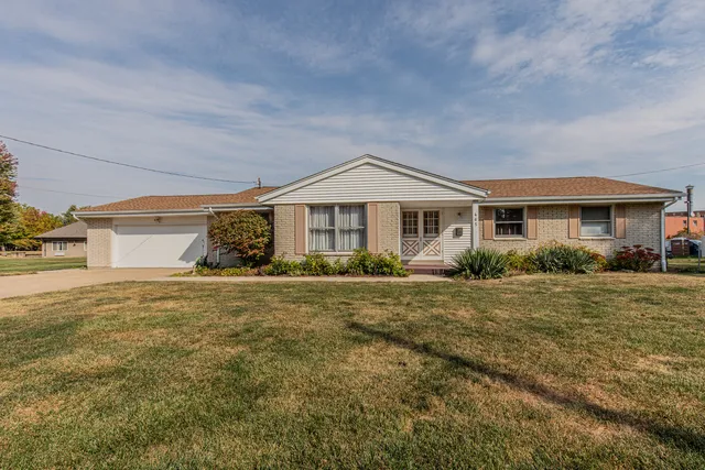 a front view of a house with a garden