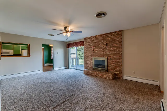 a view of a livingroom with a fireplace and a window