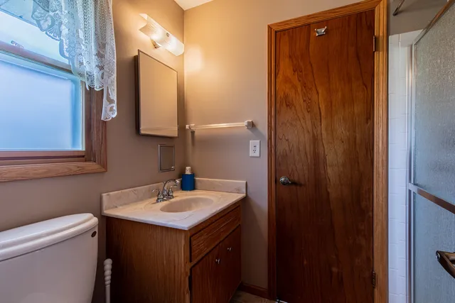 a bathroom with a sink vanity and a mirror