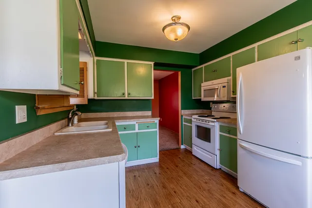 a kitchen with cabinets a sink and a stove