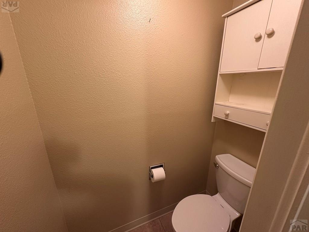 1009 Constitution Road Pueblo, CO 81001 - Photo 4 of 11 a white toilet sitting next to a white sink and vanity