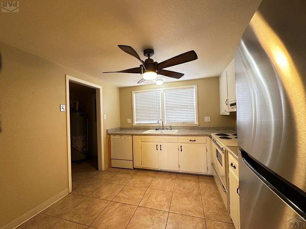 1009 Constitution Road Pueblo, CO 81001 - Photo 5 of 11 a kitchen with granite countertop a sink and stainless steel appliances
