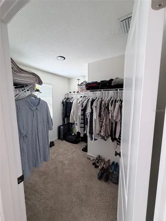 a bedroom with furniture and a wooden floor
