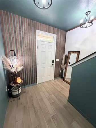 a living room with a table chairs and a window