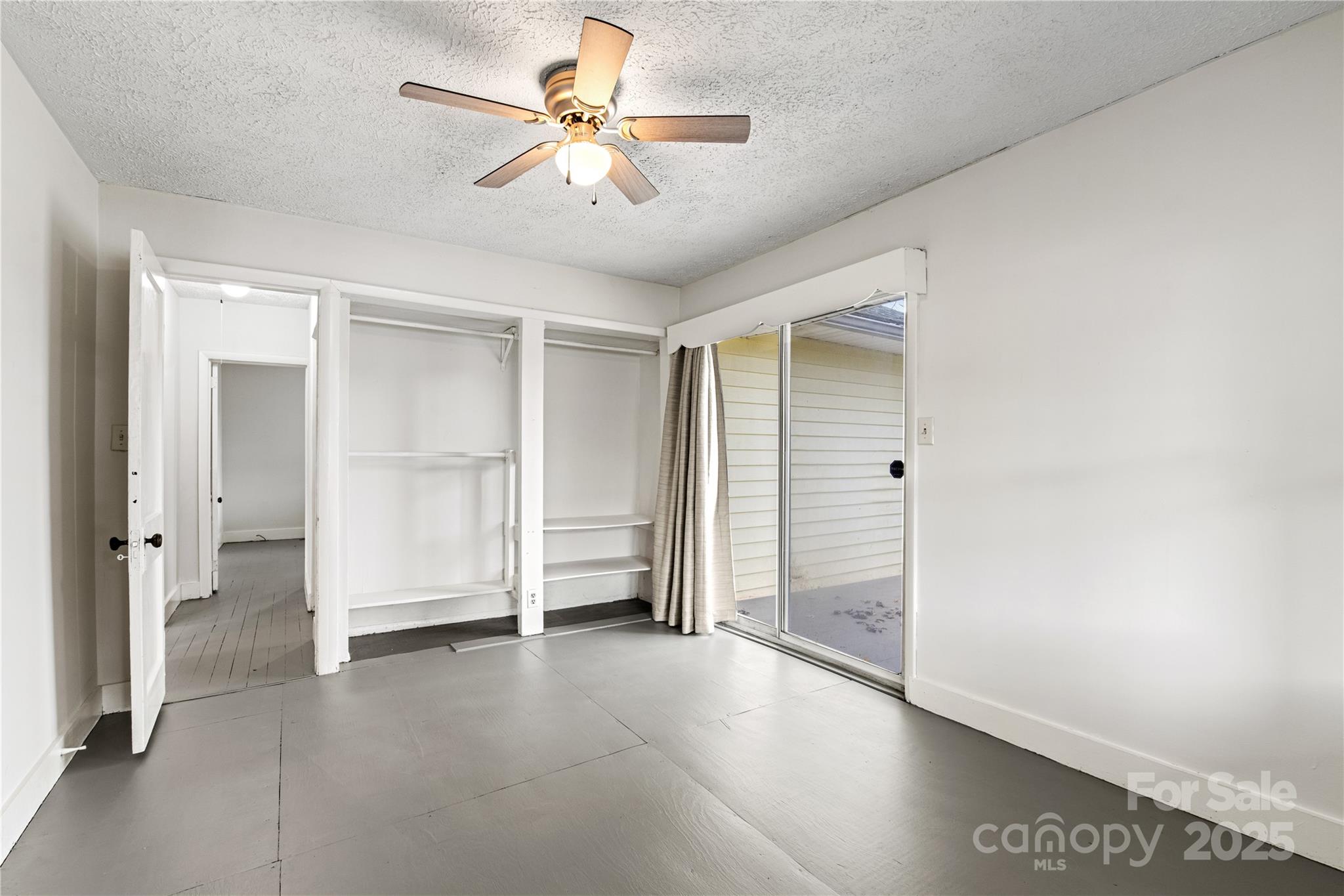 29 Le-An-Hurst Road Asheville, NC 28803 - Photo 12 of 22 wooden floor in an empty room with a ceiling fan