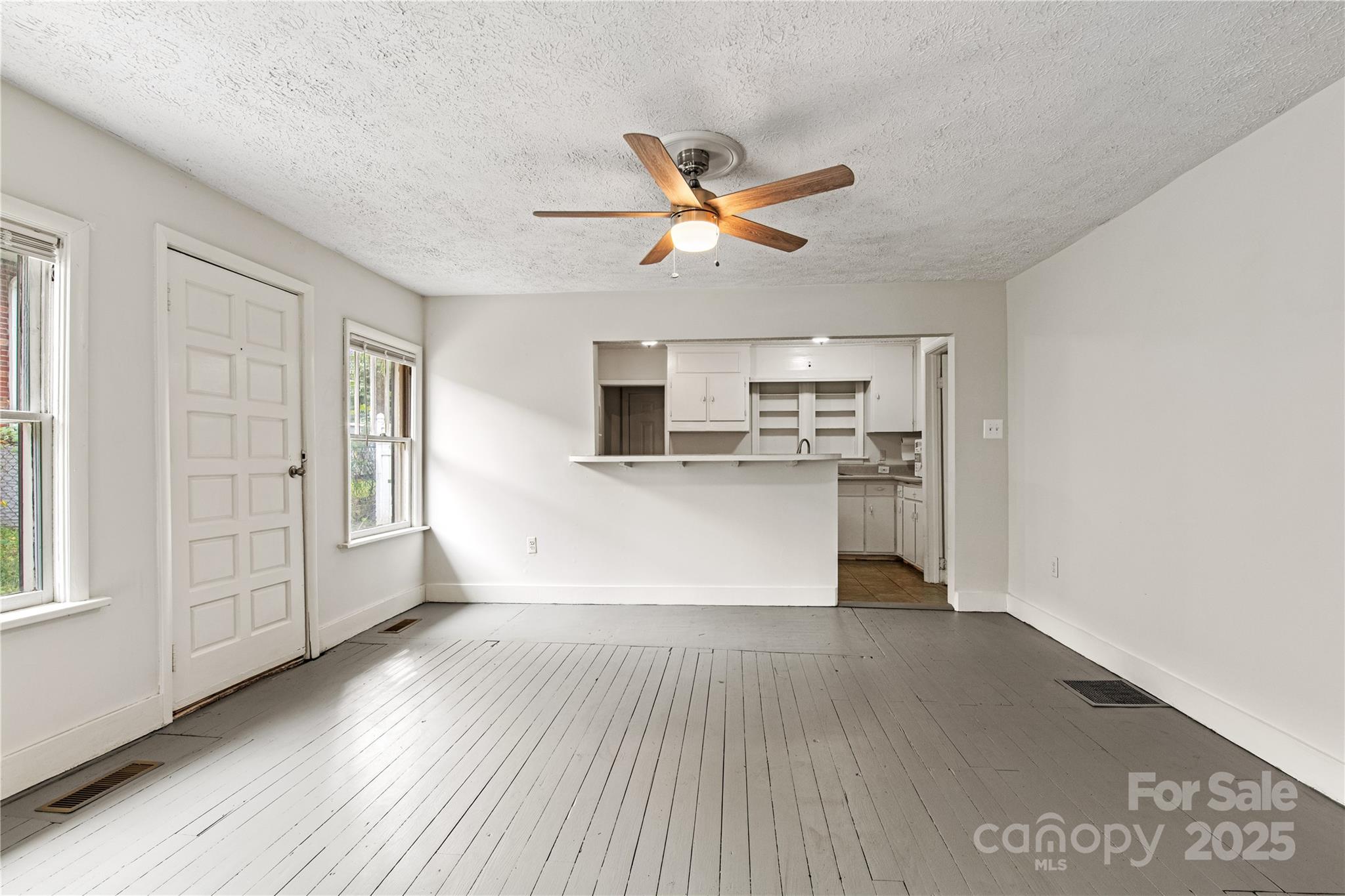 29 Le-An-Hurst Road Asheville, NC 28803 - Photo 6 of 22 a view of a kitchen with wooden floor and a ceiling fan
