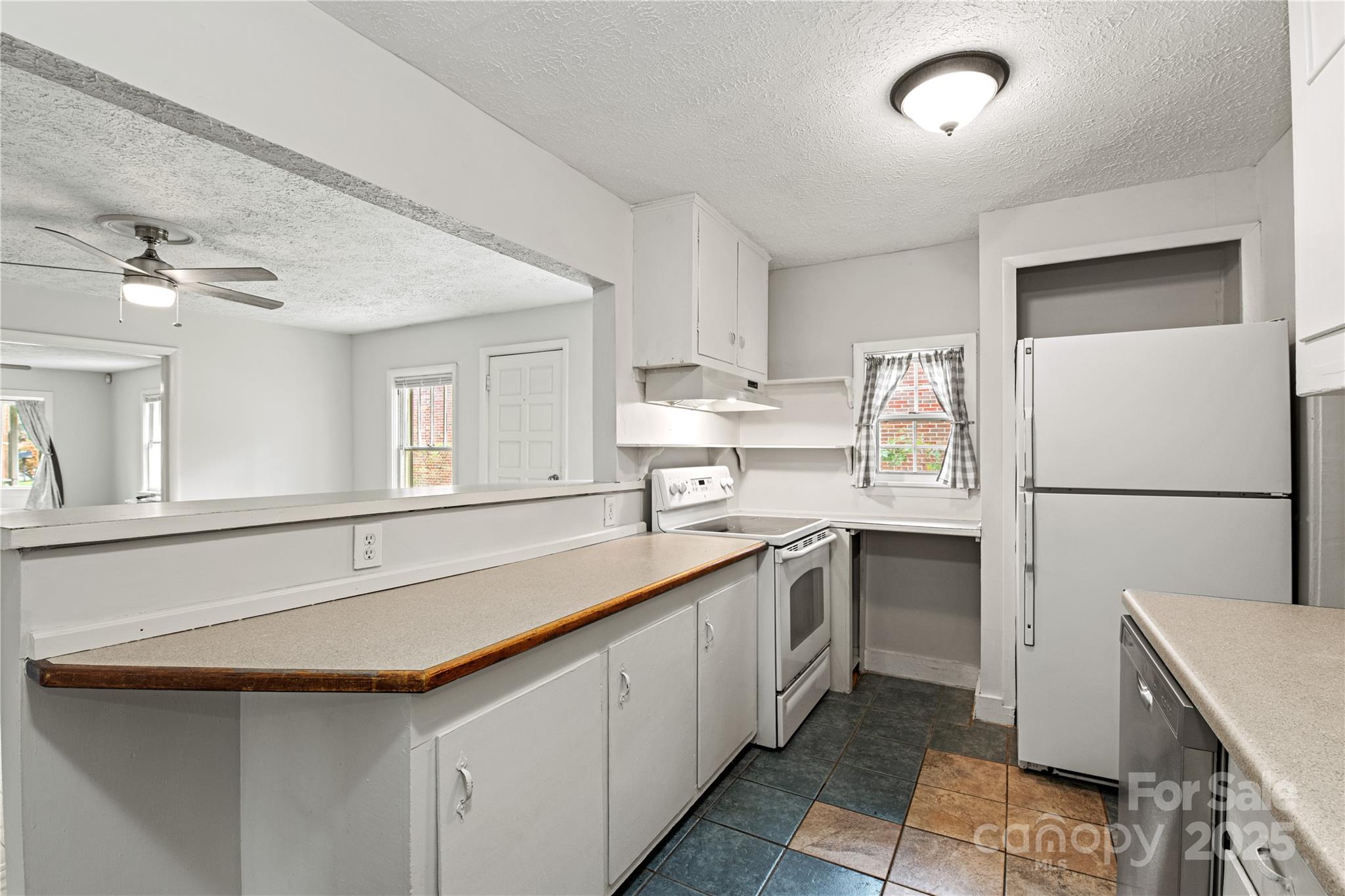 29 Le-An-Hurst Road Asheville, NC 28803 - Photo 8 of 22 a kitchen with white cabinets and sink