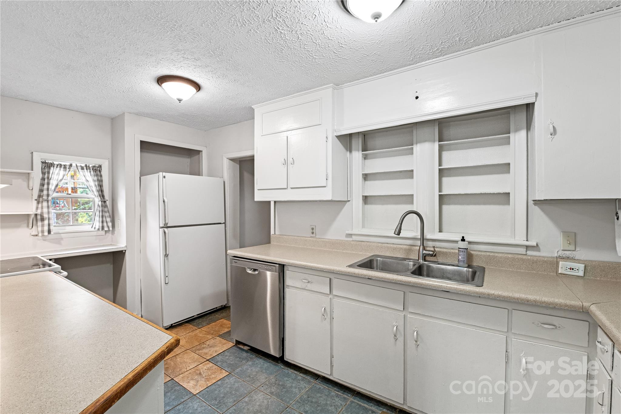 29 Le-An-Hurst Road Asheville, NC 28803 - Photo 10 of 22 a kitchen with a sink a refrigerator and window