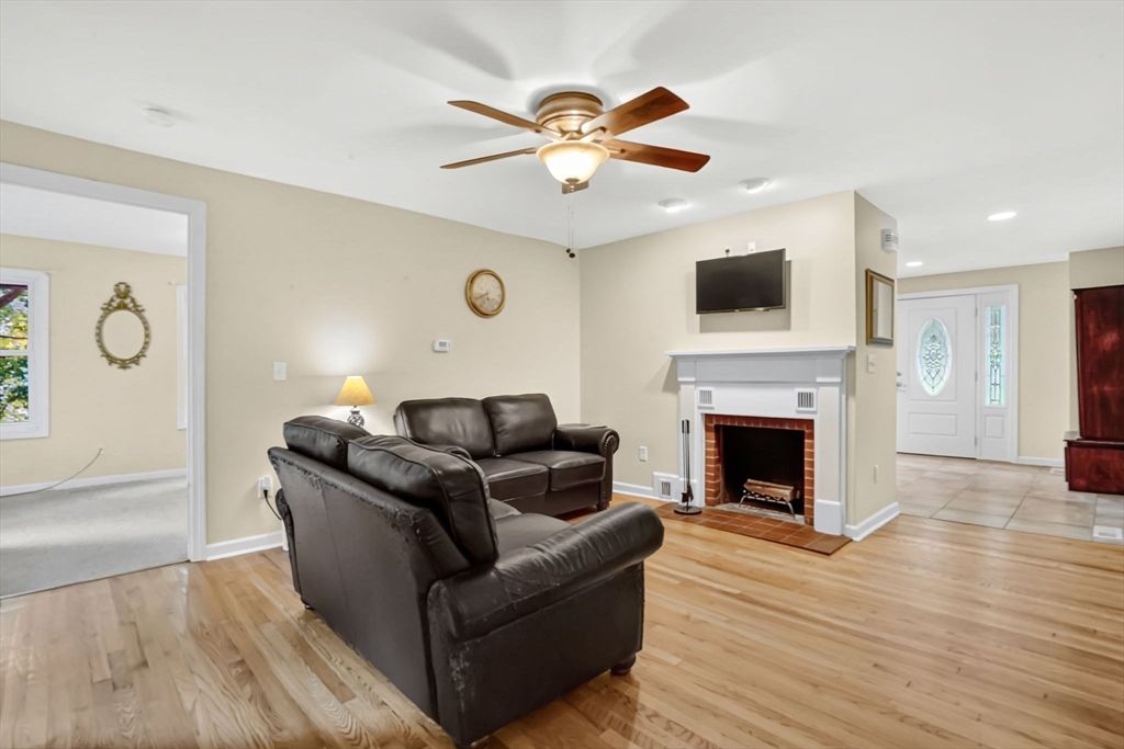 407 Monson Road Wilbraham, MA 01095 - Photo 8 of 38 a living room with furniture a fireplace and a flat screen tv