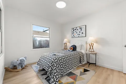 a bedroom with a bed and a couch