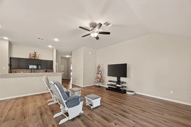 a view of a workspace with furniture and wooden floor