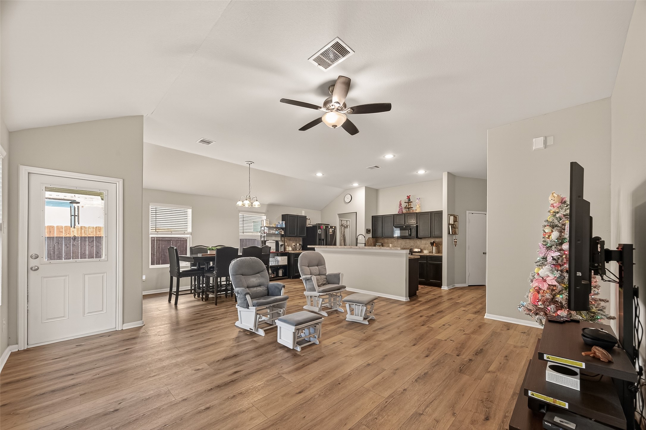 11311 Cascading Stream Way Houston, TX 77044 - Photo 13 of 33 a living room with furniture kitchen view and a wooden floor