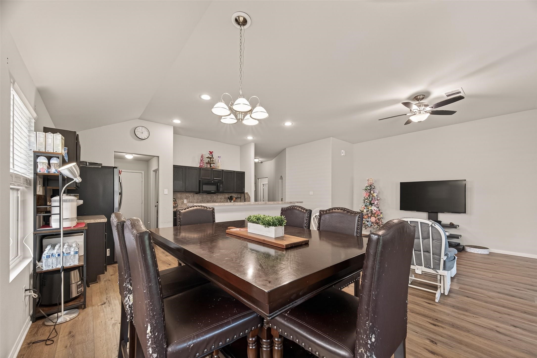 11311 Cascading Stream Way Houston, TX 77044 - Photo 15 of 33 a view of a dining room with furniture and wooden floor