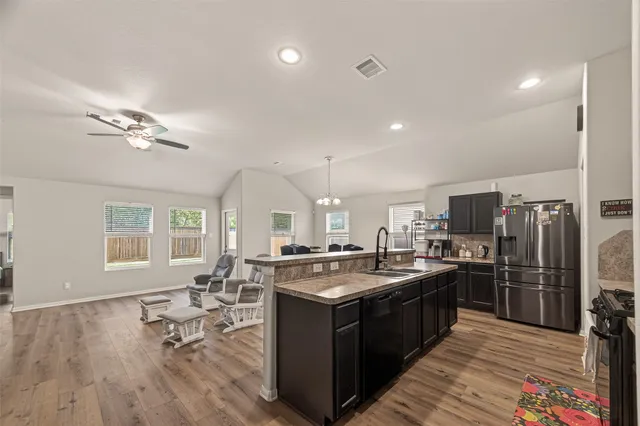 a kitchen with lots of counter top space and stainless steel appliances