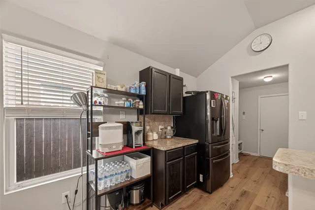 a kitchen with stainless steel appliances granite countertop a refrigerator stove and sink