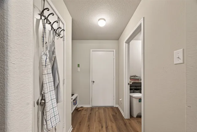 a view of hallway with wooden floor