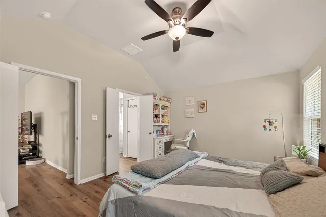 a bedroom with a large bed and a chandelier