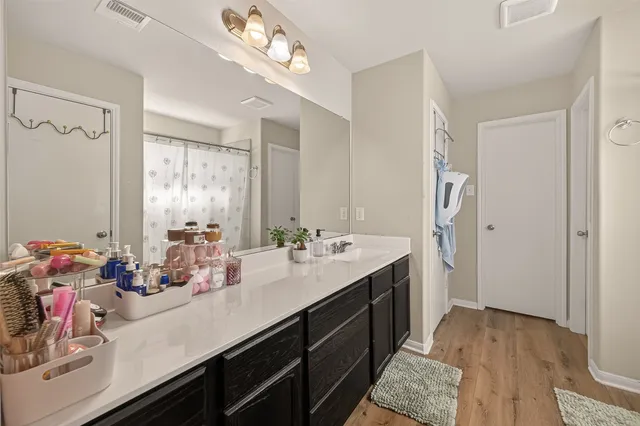 a bathroom with a sink double vanity and a mirror