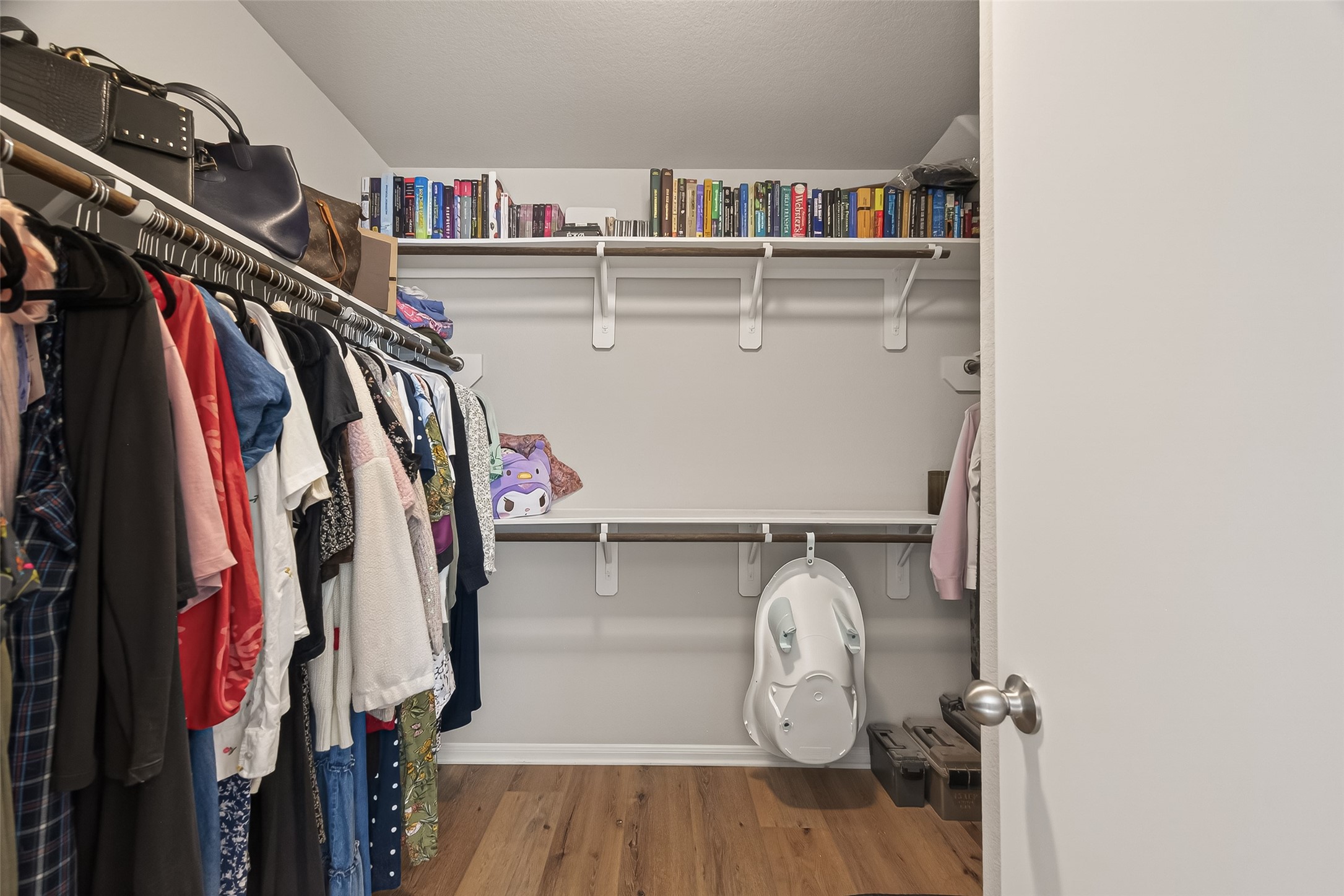 11311 Cascading Stream Way Houston, TX 77044 - Photo 28 of 33 a view of walk in closet with clothes and shoes