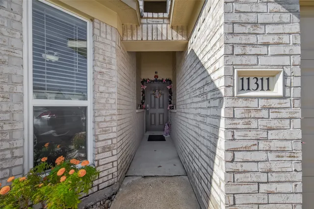a pathway of a house with a yard