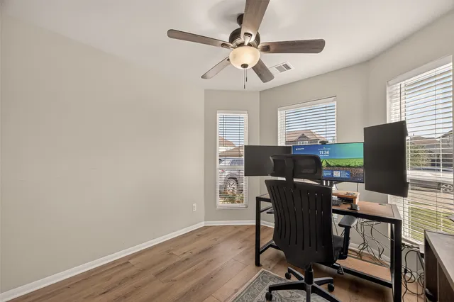 a view of a workspace with furniture and a window