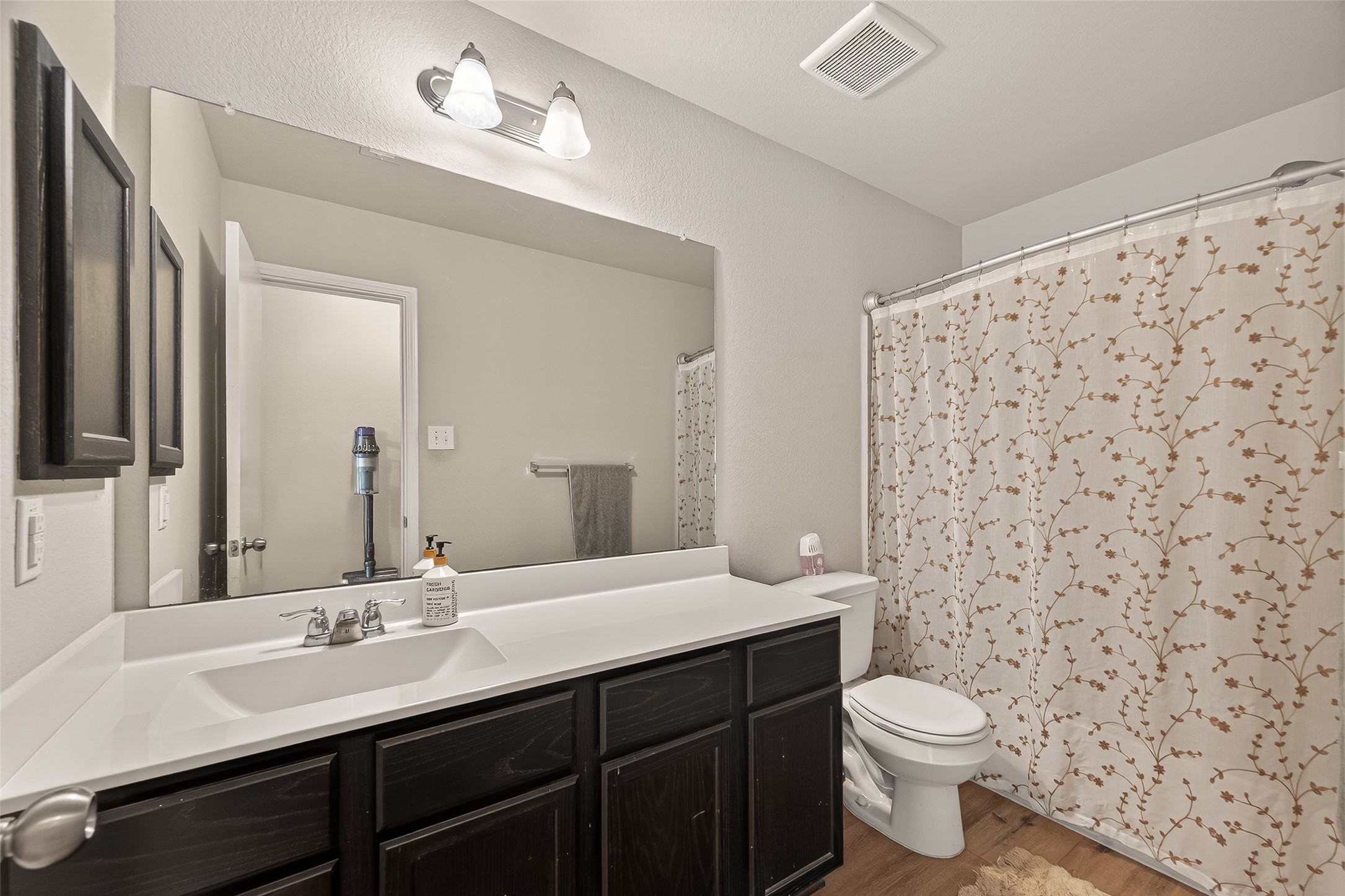 11311 Cascading Stream Way Houston, TX 77044 - Photo 9 of 33 a bathroom with a sink a toilet a mirror and shower curtain