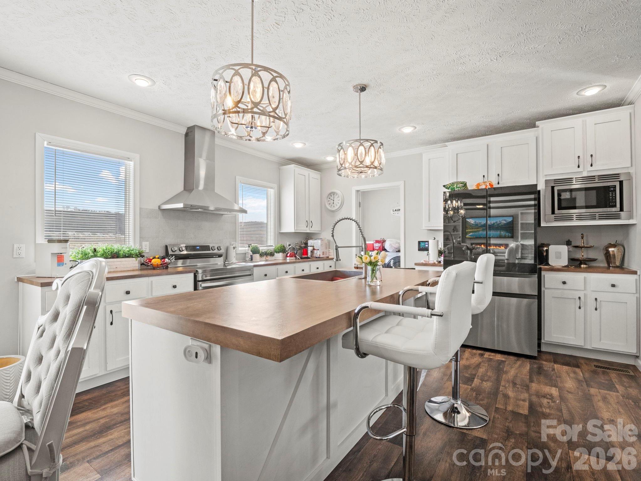 1796 Pilot Mountain Road Hendersonville, NC 28792 - Photo 15 of 26 a very nice looking kitchen with granite countertop a stove a sink a dining table and chairs