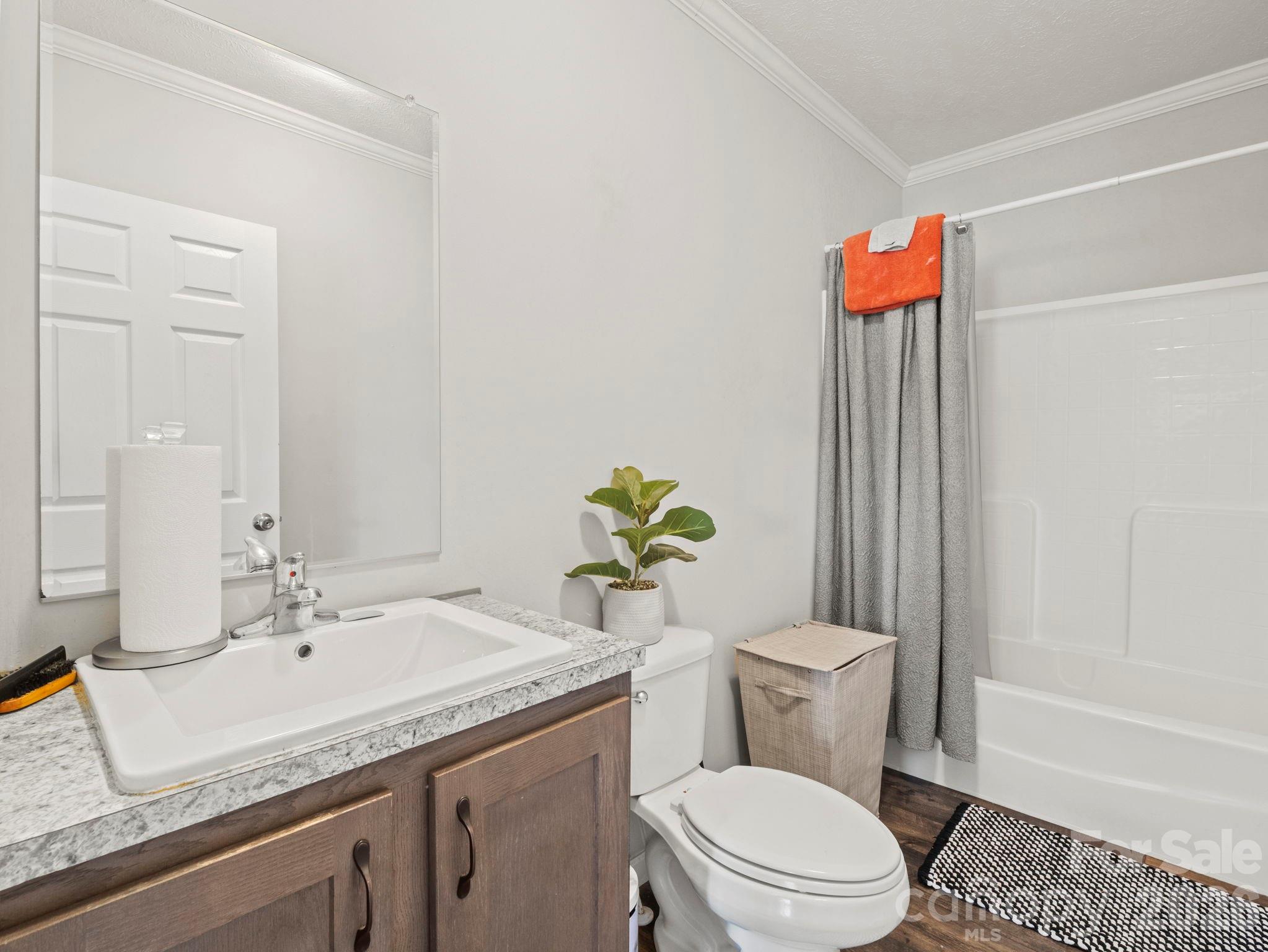 1796 Pilot Mountain Road Hendersonville, NC 28792 - Photo 19 of 26 a bathroom with a granite countertop sink a toilet and shower