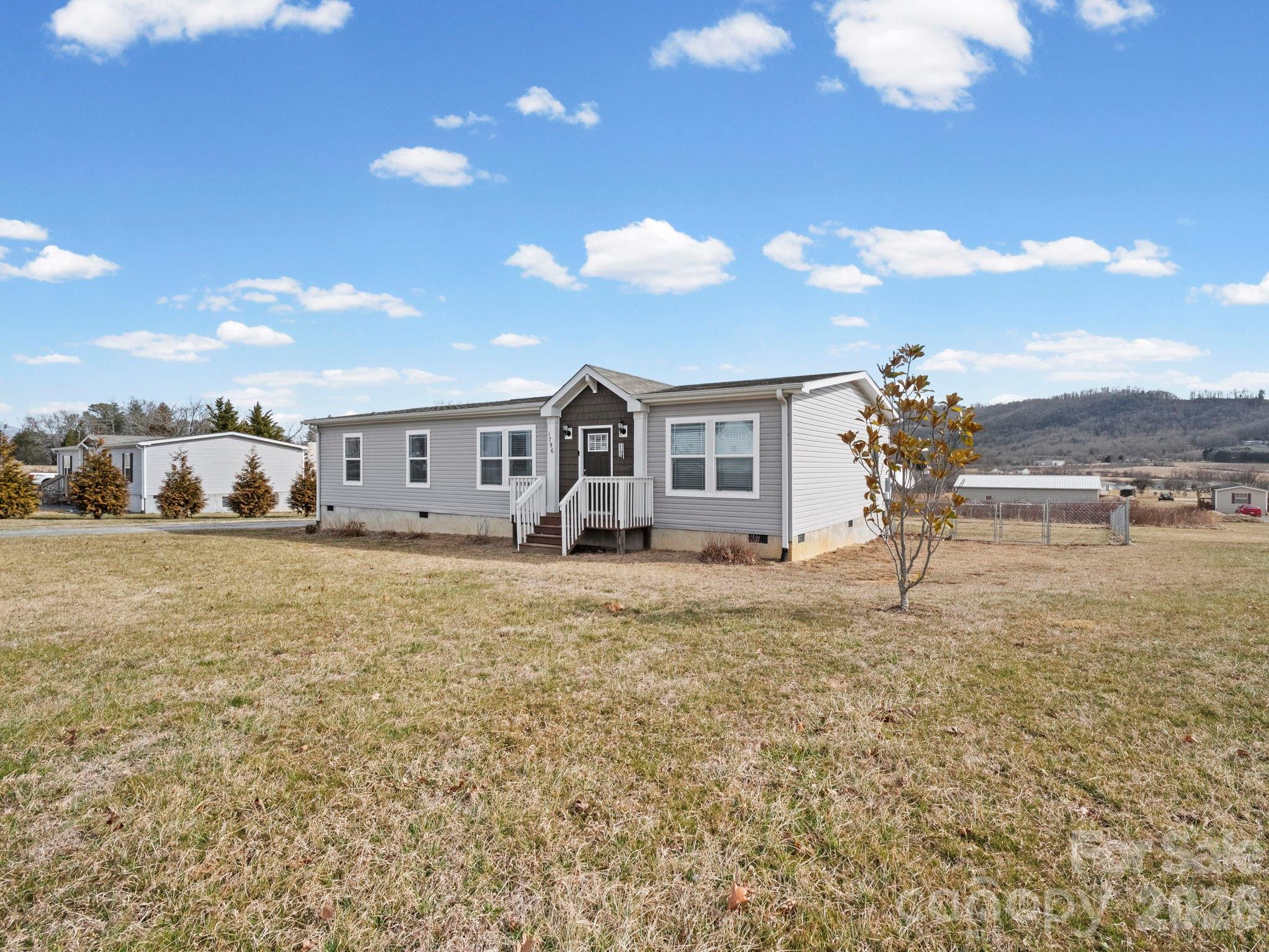 1796 Pilot Mountain Road Hendersonville, NC 28792 - Photo 2 of 26 a view of a house with a yard