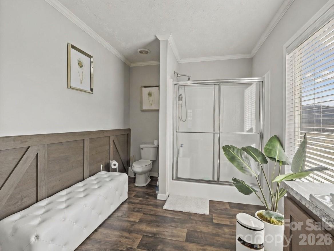 1796 Pilot Mountain Road Hendersonville, NC 28792 - Photo 25 of 26 a spacious bedroom with a bed and a couch