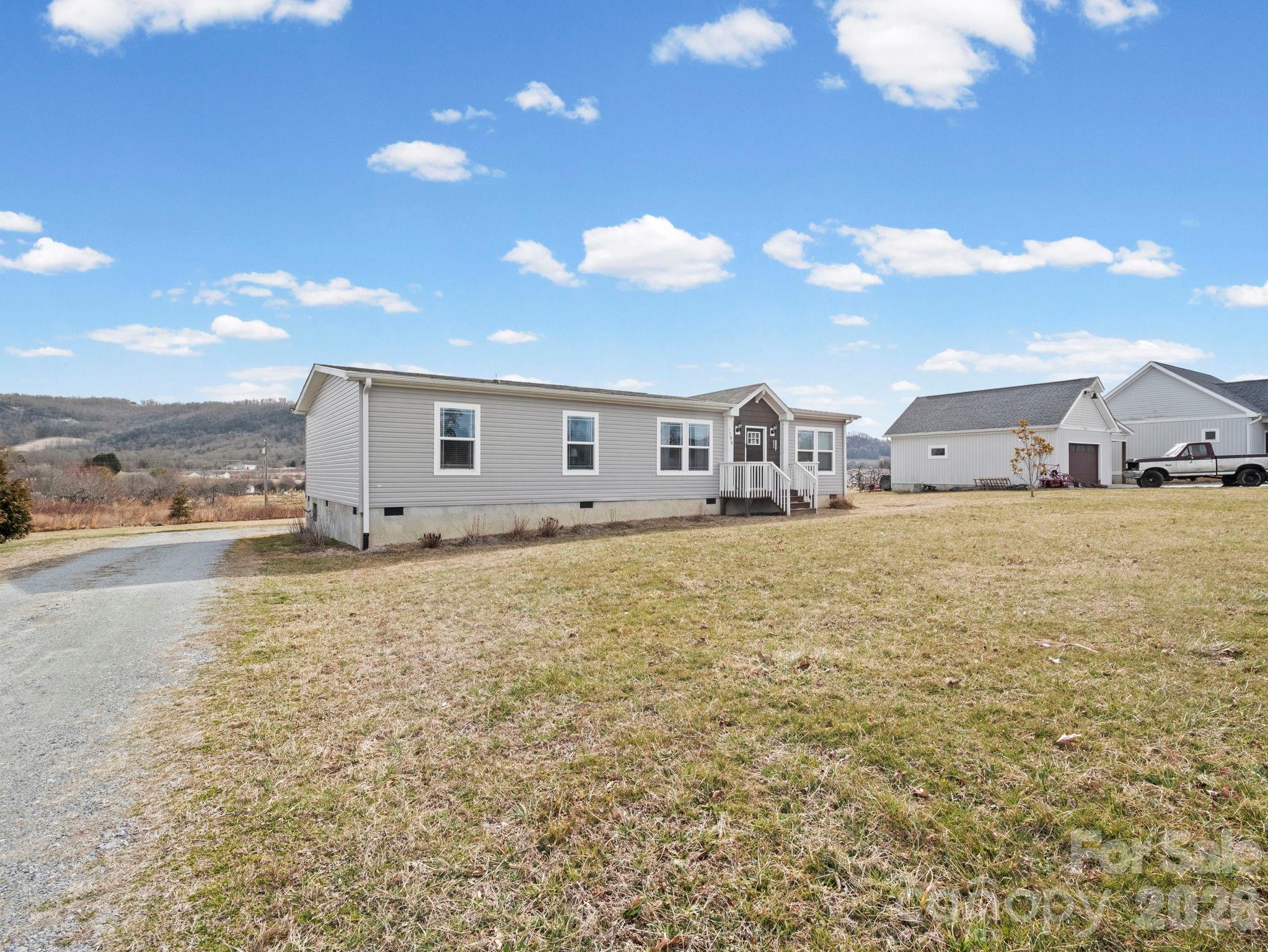 1796 Pilot Mountain Road Hendersonville, NC 28792 - Photo 3 of 26 a bathroom with a sink and a large mirror