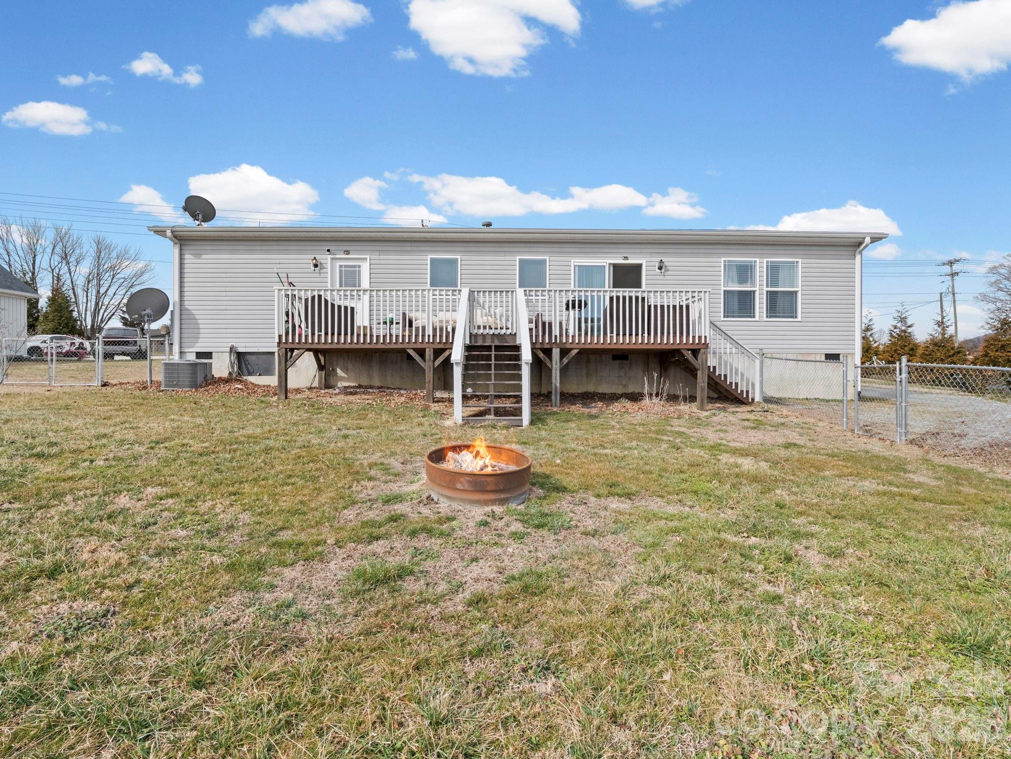 1796 Pilot Mountain Road Hendersonville, NC 28792 - Photo 6 of 26 a front view of a house with a garden and outdoor seating