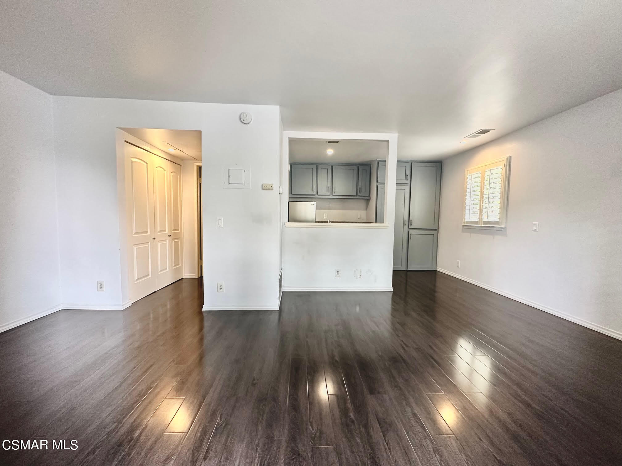 4541 Alamo Street, Unit A Simi Valley, CA 93063 - Photo 13 of 20 a view of an empty room with wooden floor and a window