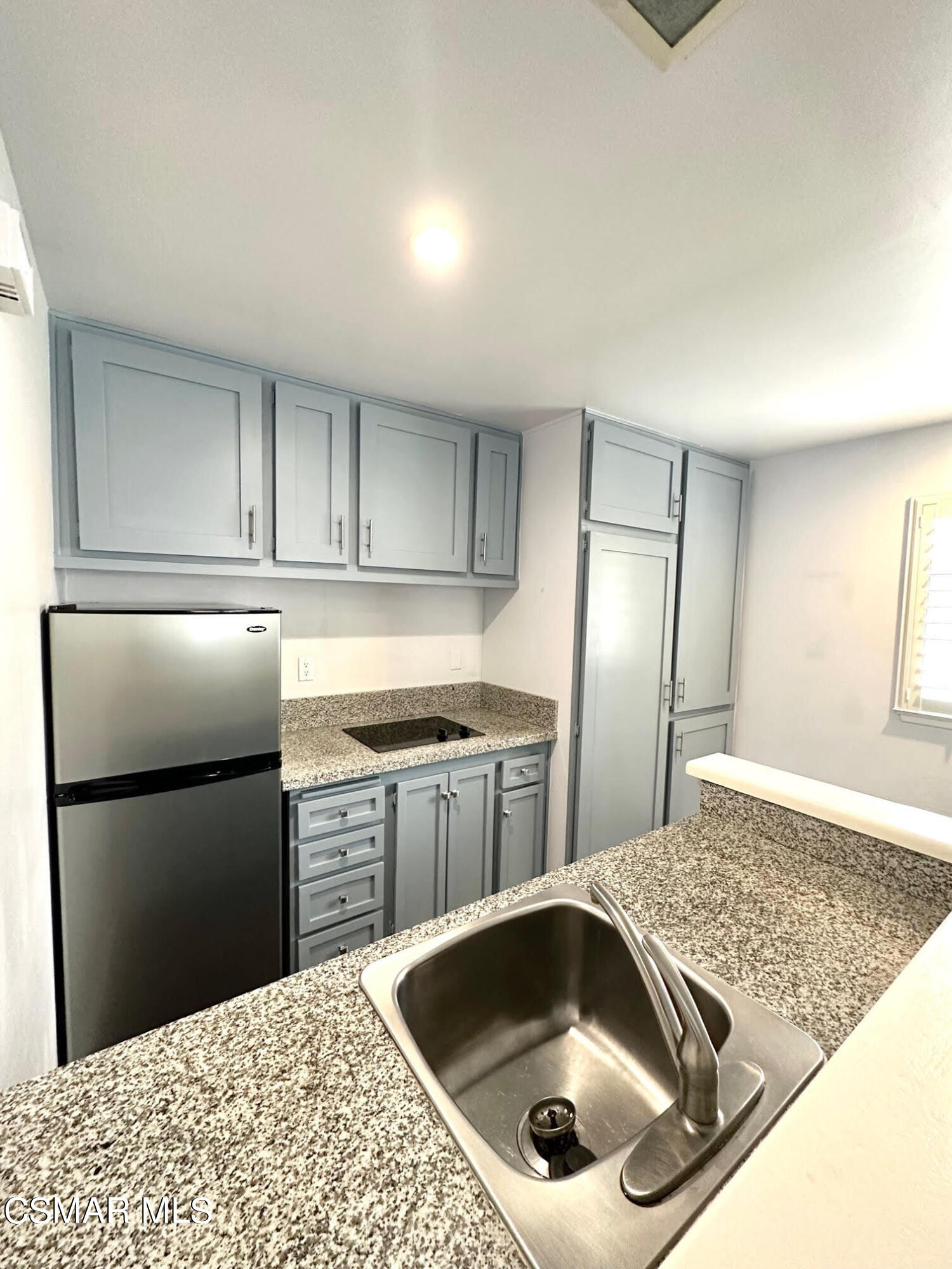 4541 Alamo Street, Unit A Simi Valley, CA 93063 - Photo 16 of 20 a kitchen with a refrigerator sink and cabinets